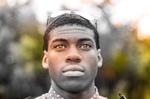 Black man wearing sunglasses, looking for sky